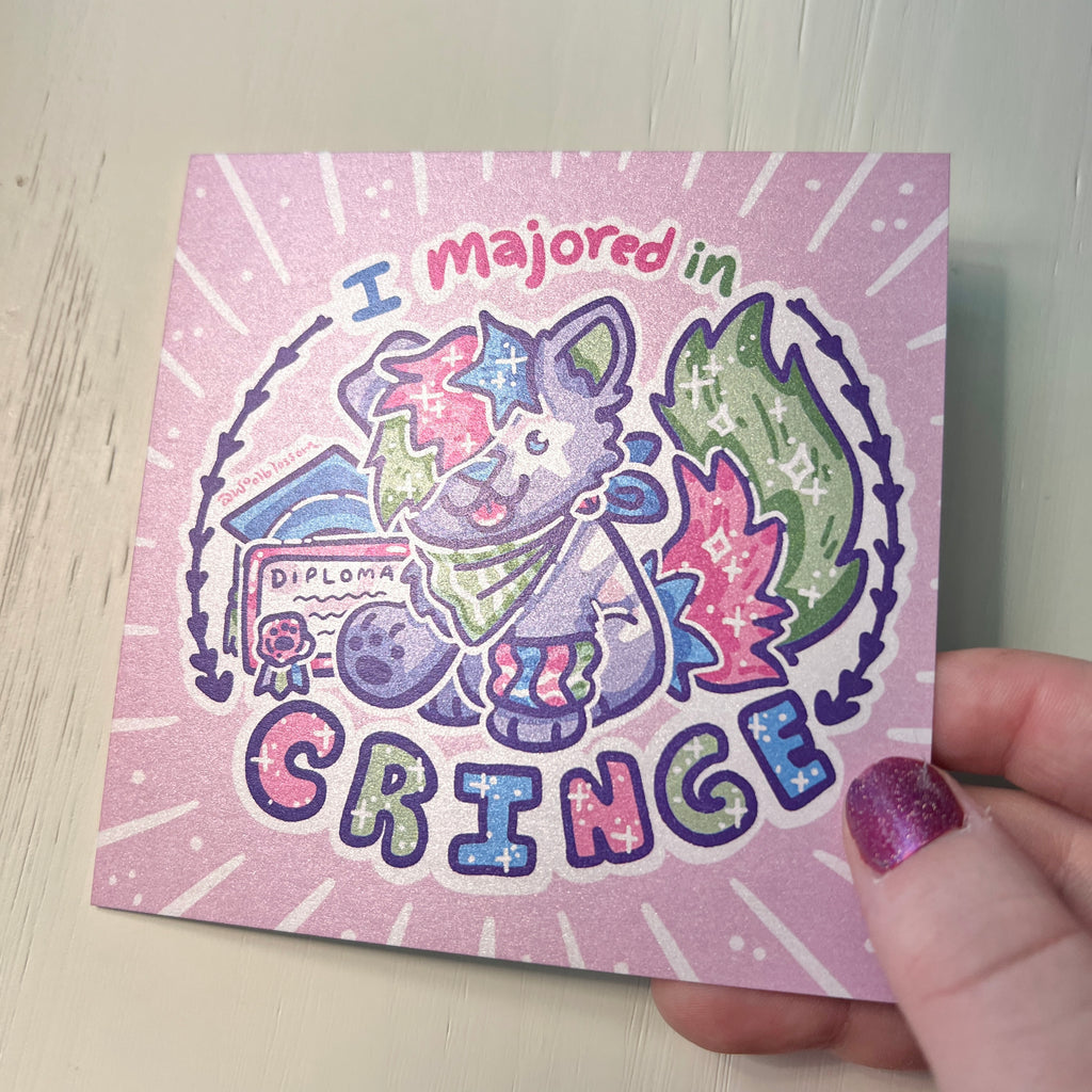 Print with cartoon sparkle dog and text 'I majored in cringe' held by a hand