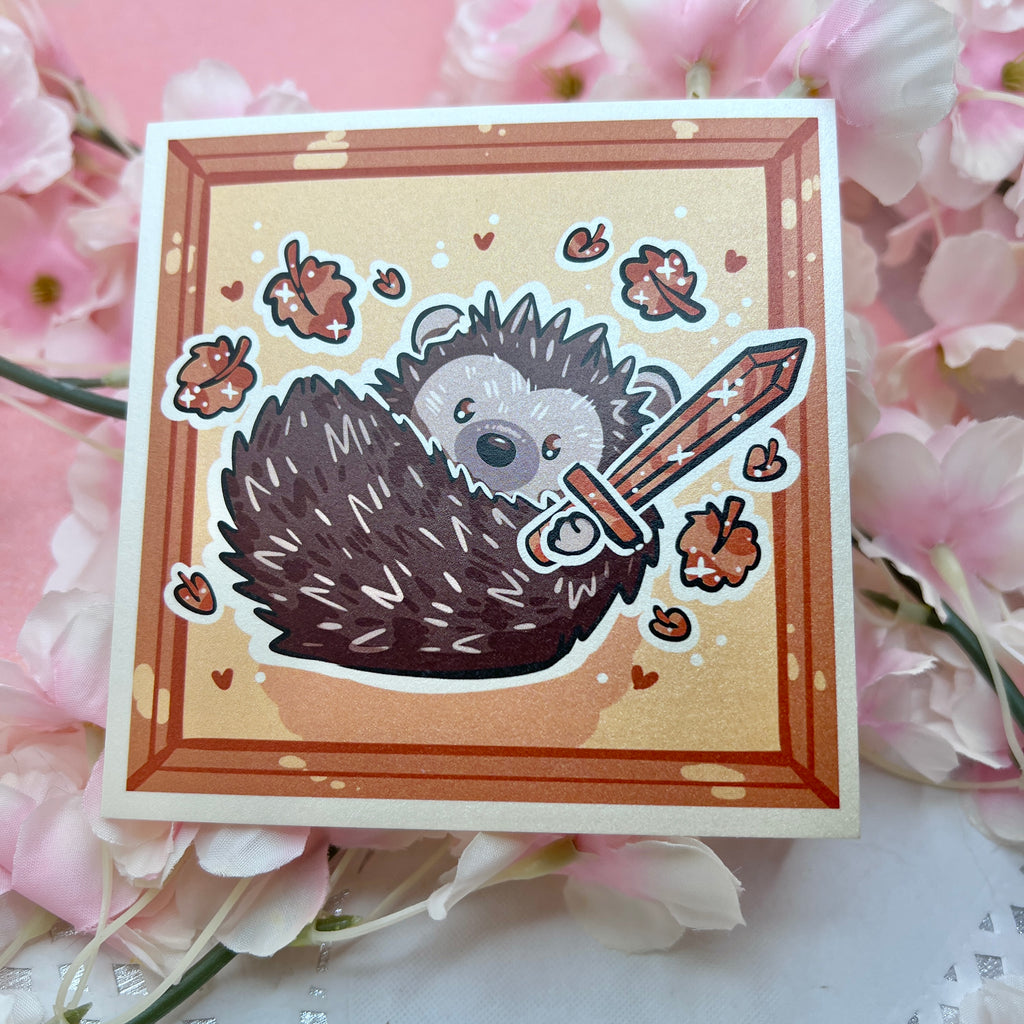 A print of a hedgedhog holding a sword with orange leaves falling around him