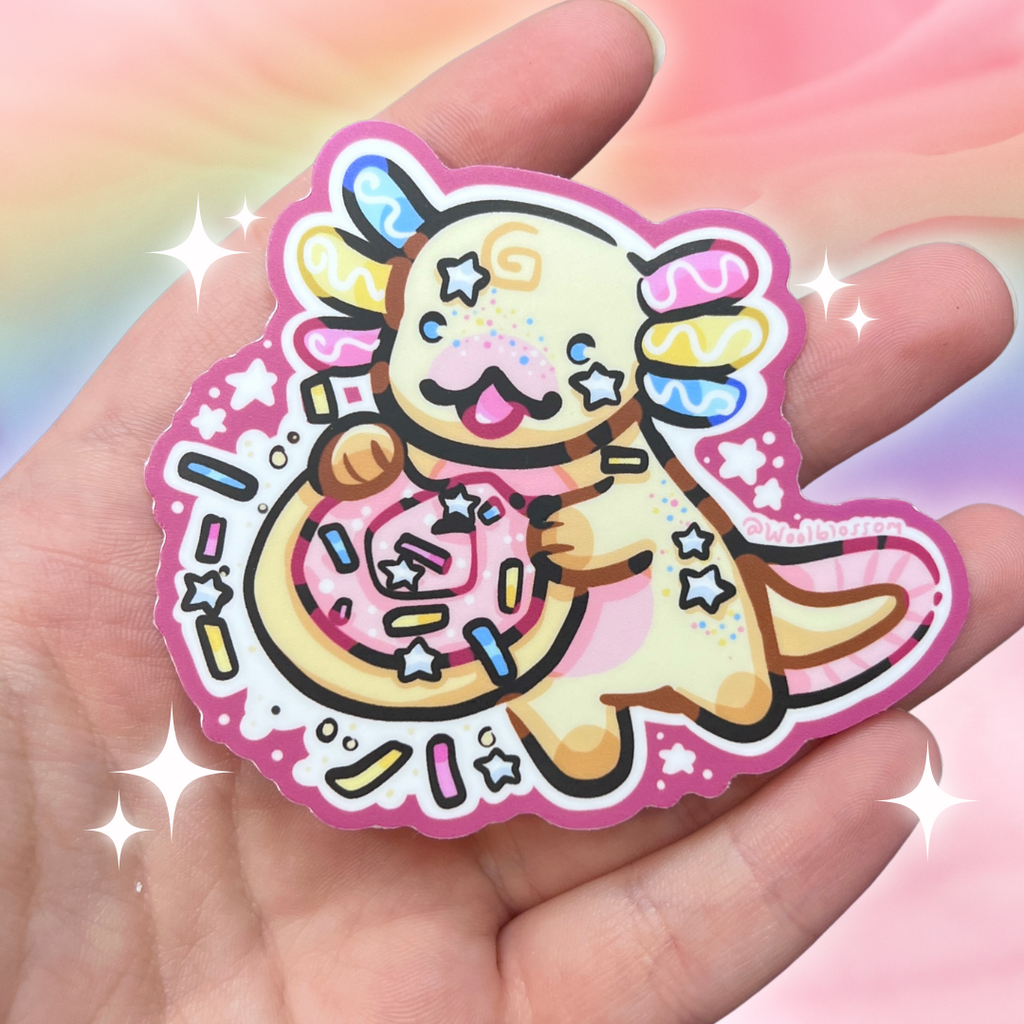 A sticker of a sugar cookie inspired axolotl holding a sugar cookie with sprinkles