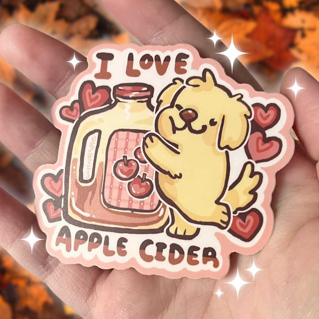 Sticker with a dog holding an apple cider jar and 'I love apple cider' text on a hand.