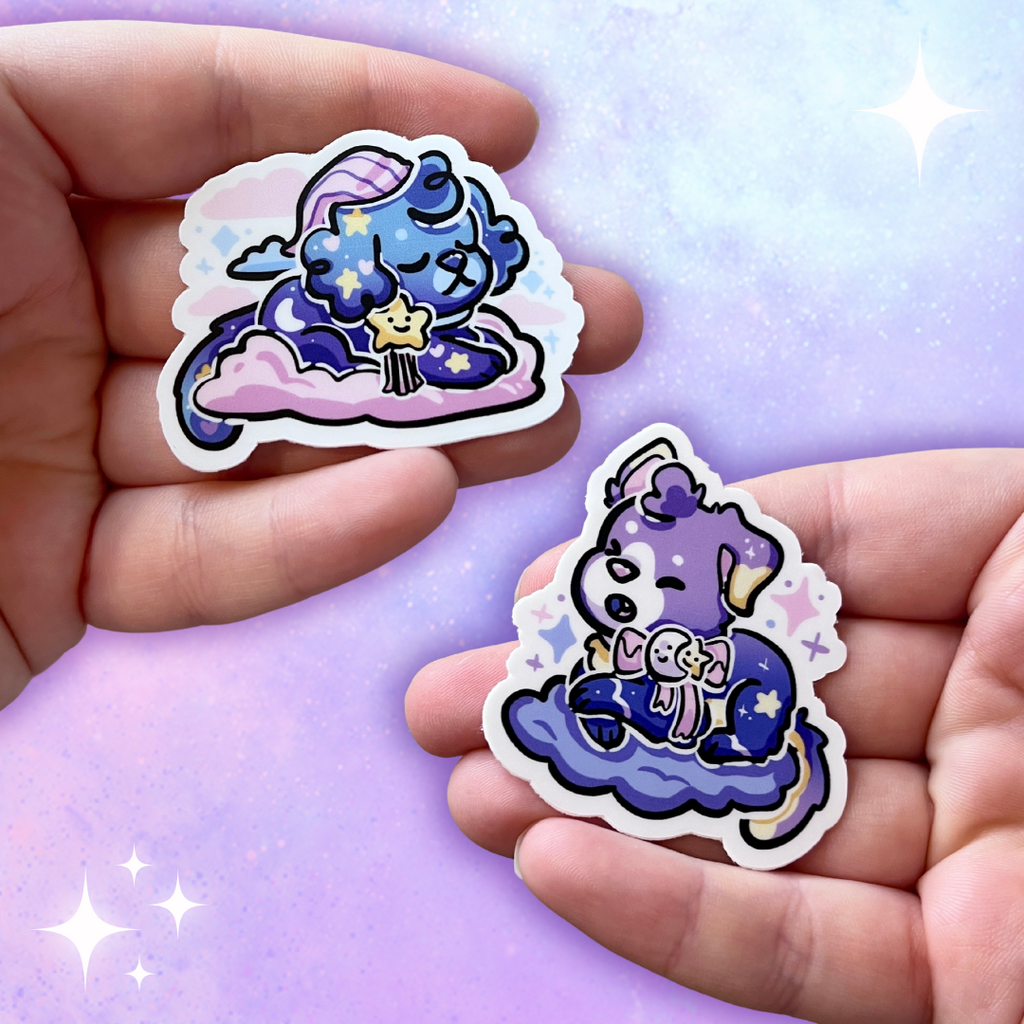 Two stickers of two puppies. One is blue with a bedtime cap, blue skin, and star bow on a pink cloud. The second has a purple gradient skin, moon/star bow, and is on a purple cloud.