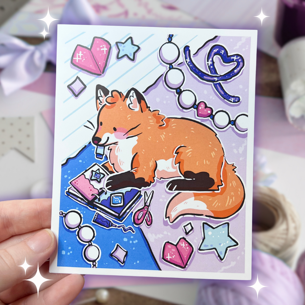 A print of a cute red fox scrapbooking away