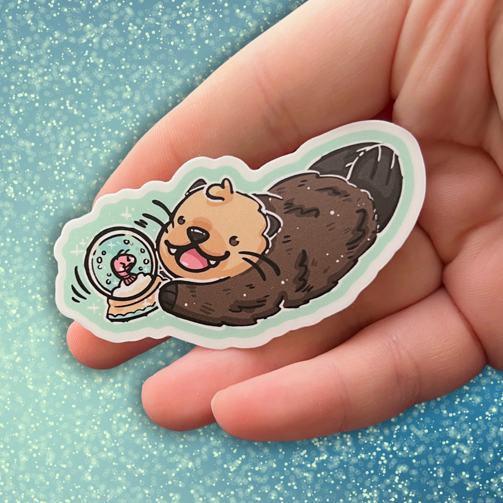 A sticker of an otter shaking a snowglobe (that has a tiny upset shrimp inside)