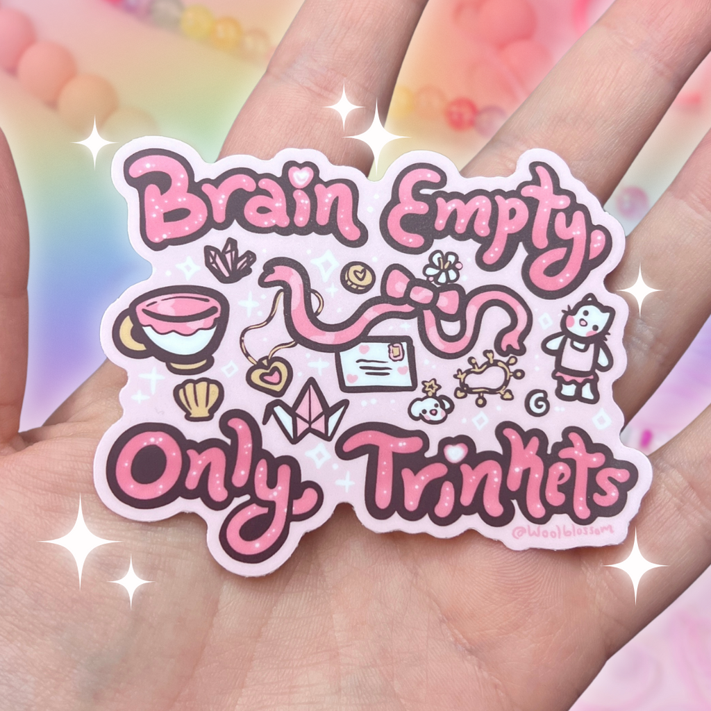 A sticker that says "brain empty, only trinkets" with various little pink items around it