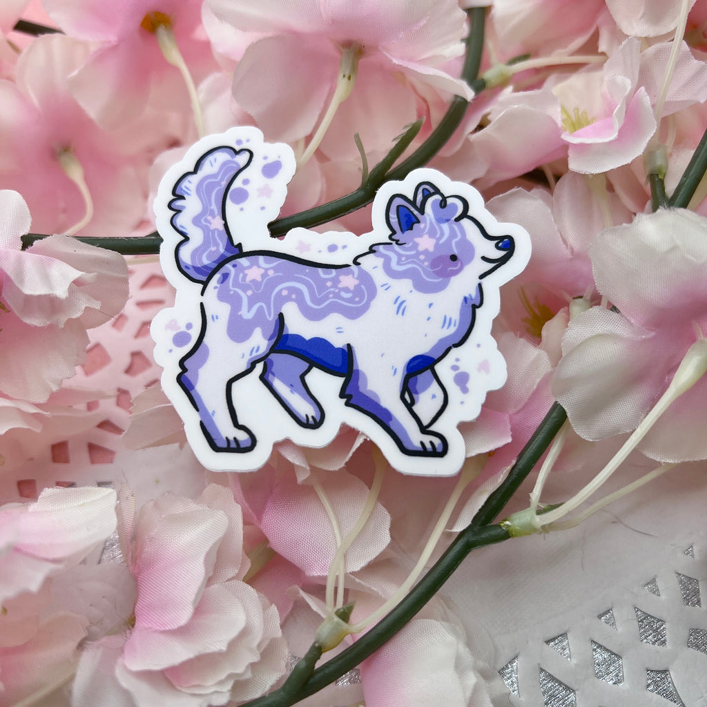 a sticker of a collie but the pattern is white with purple paint like splotches