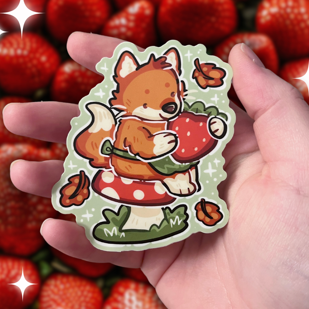 A sticker of a red fox with a little green apron sitting on a red mushroom, holding a strawberry with autumn leaves falling