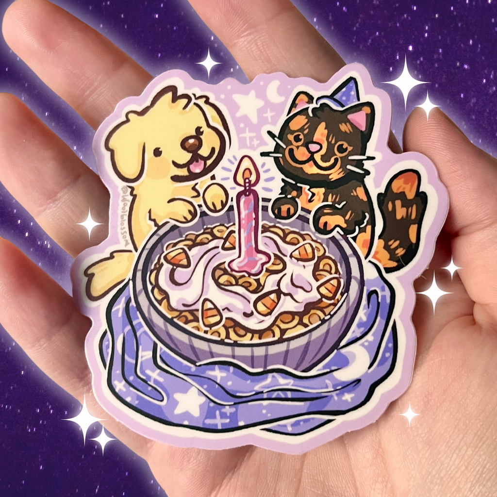 Sticker of a dog and cat by a birthday cereal with a candle held in a hand against a starry background.