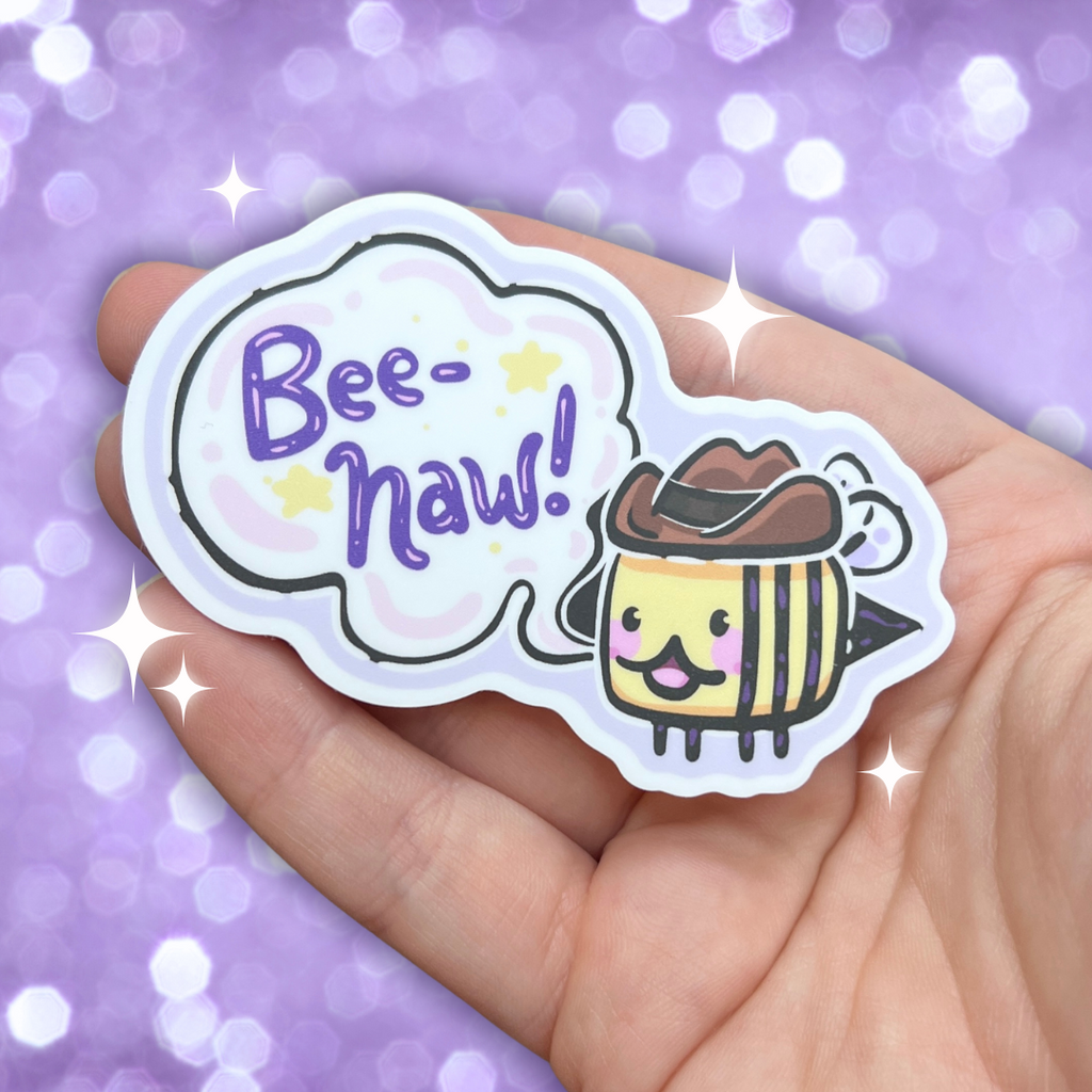 A sticker of a bee with a cowboy hat and a speech bubble that says "bee-haw!"