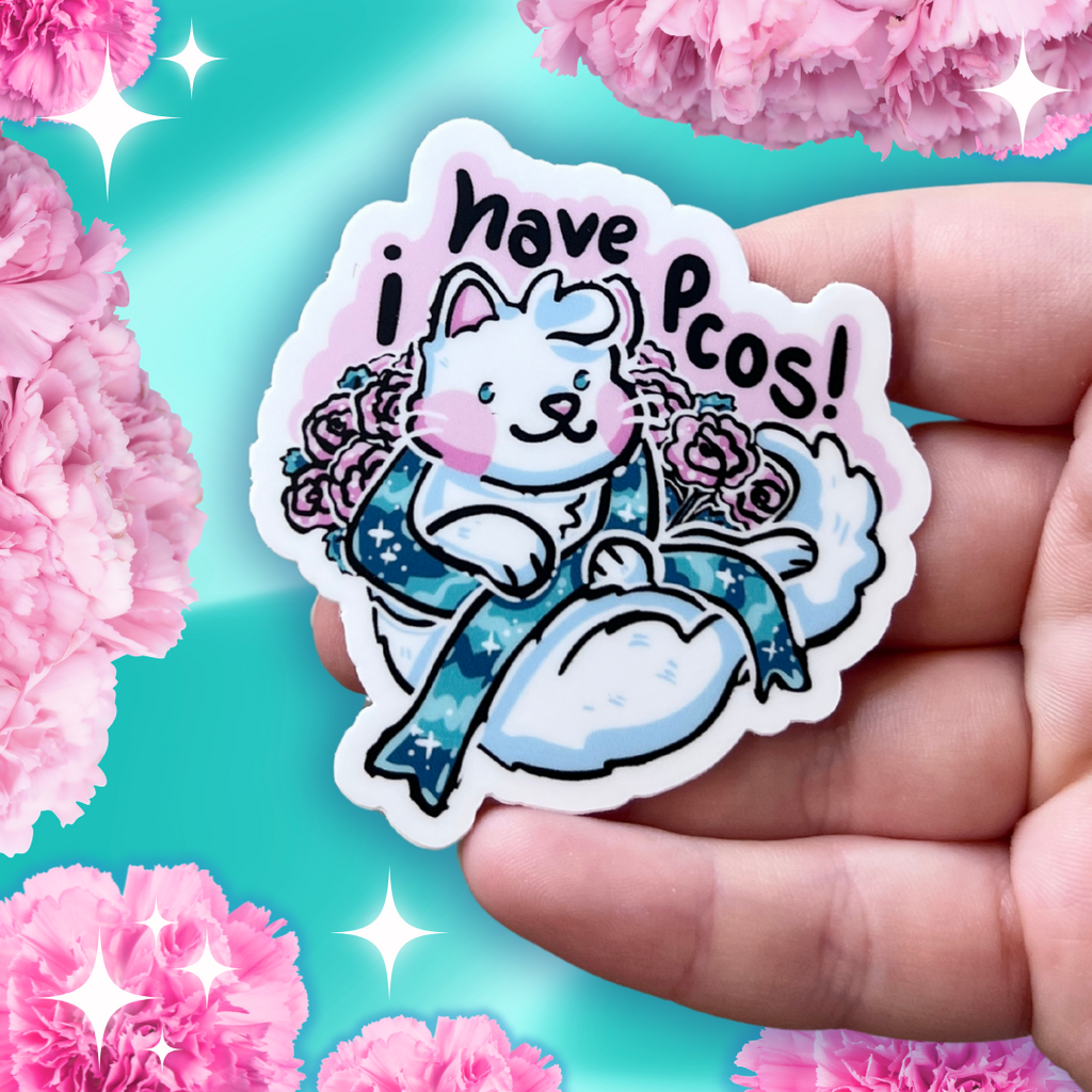 a sticker of a white cat surrounded by pink carnations. the cat is holding a teal condition ribbon and above them is the text "i have pcos"