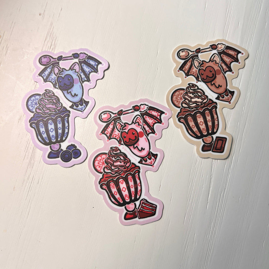 3 colorful bat-themed stickers that are stain glass and ice cream themed on white