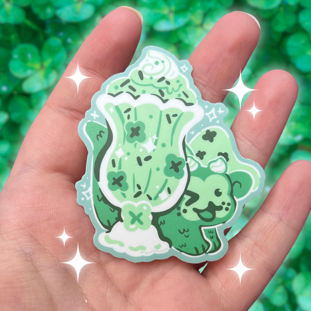 A sticker of a clover mint shake dragon behind said shake