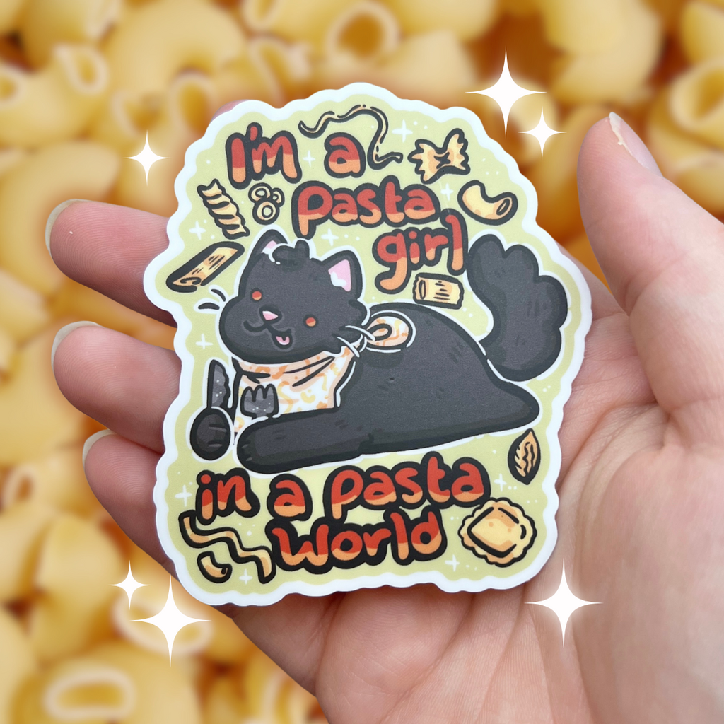 a sticker of a chonky black cat laying with a bib and utensils in hand, various pasta shapes floating around, with text that says "im a pasta girl, in a pasta world"