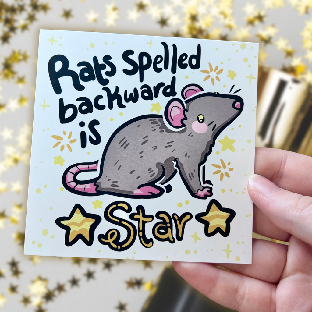 a print of a gray rat with the text "rats spelled backward is star" and gold star accents