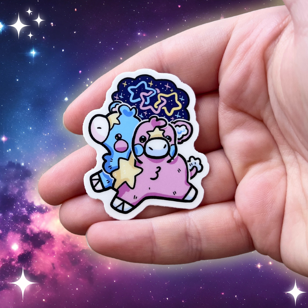 A sticker of a two headed calf, one is blue and one is pink, with a yellow star pattern connecting them and on each forehead. On top is a starry sky with three interlocking stars, one blue, one pink, and one yellow.