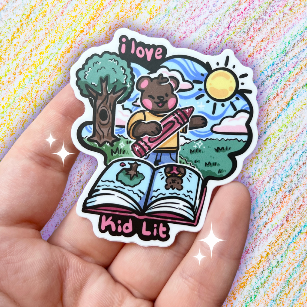 A book genre inspired sticker that says "I love kid lit" and features a bear with a crayon