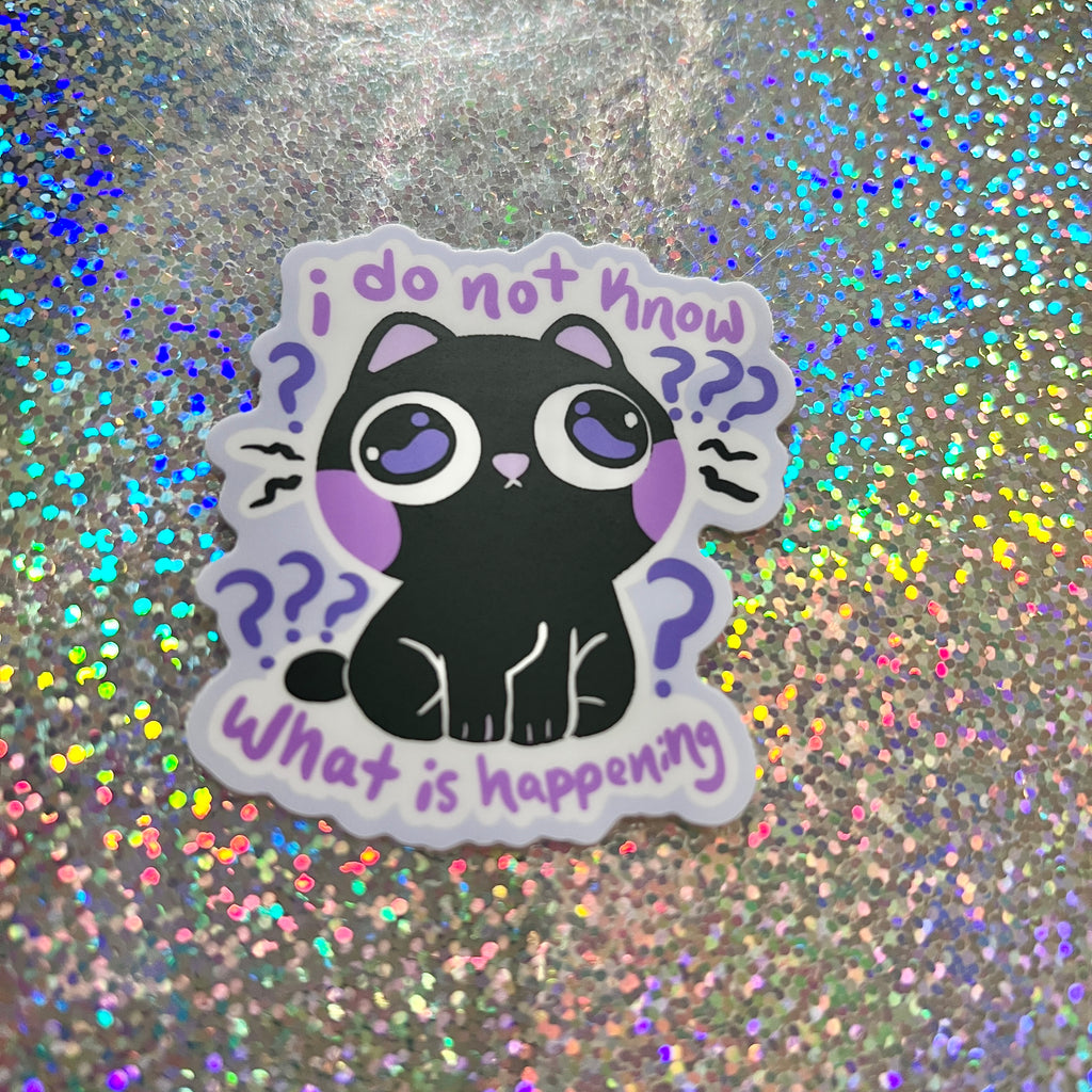 Sticker with a black cat illustration that says "i do not know what is happening" on a glittery background