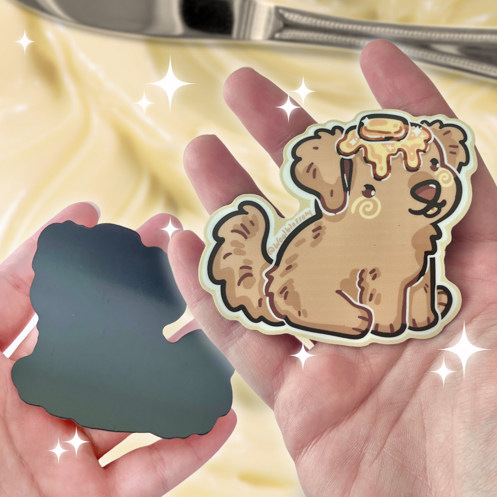 A magnet of a golden retriever puppy with butter on its head