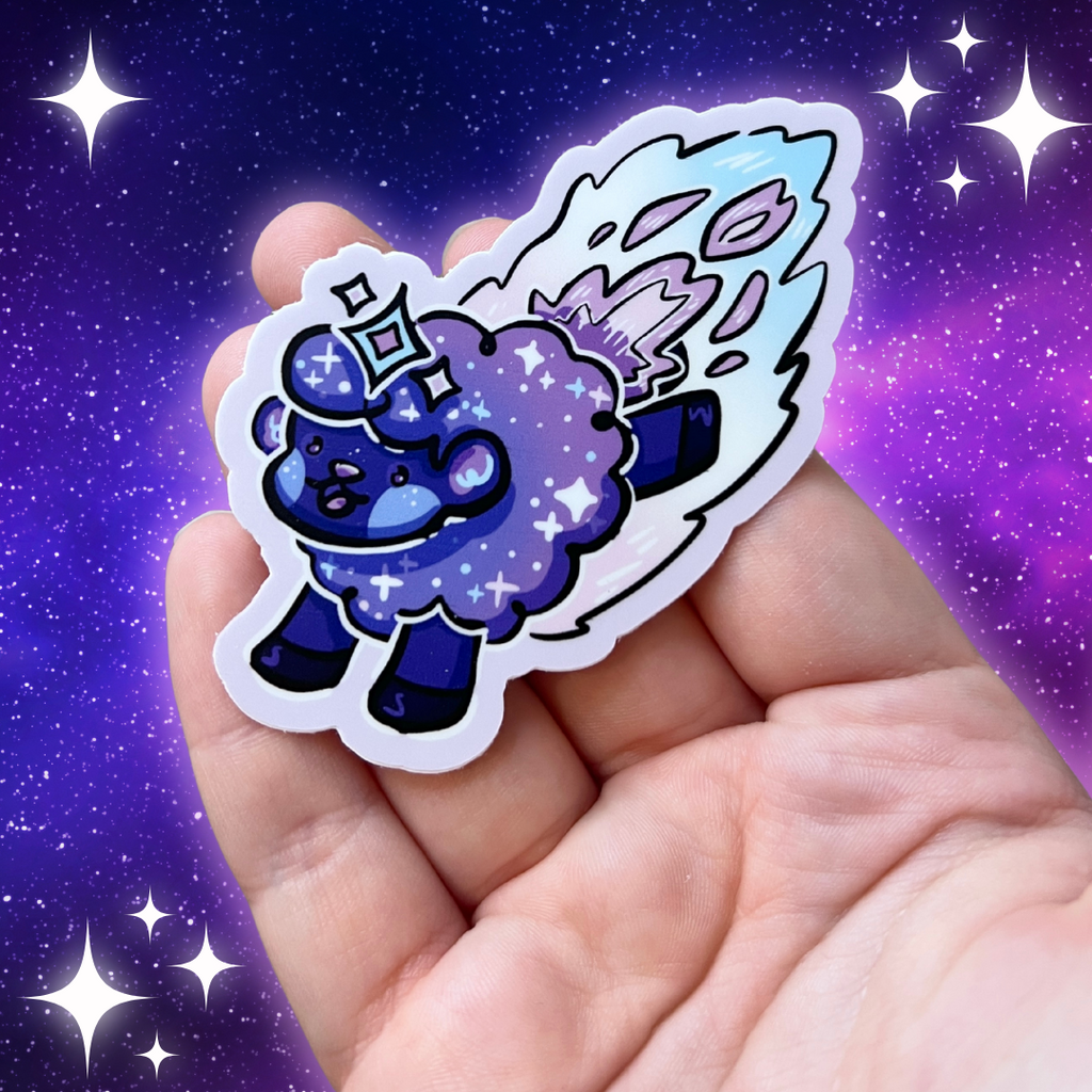 a sticker of a dark purple/blue sheep made to seem like a shooting star, with glittery details and trail behind them