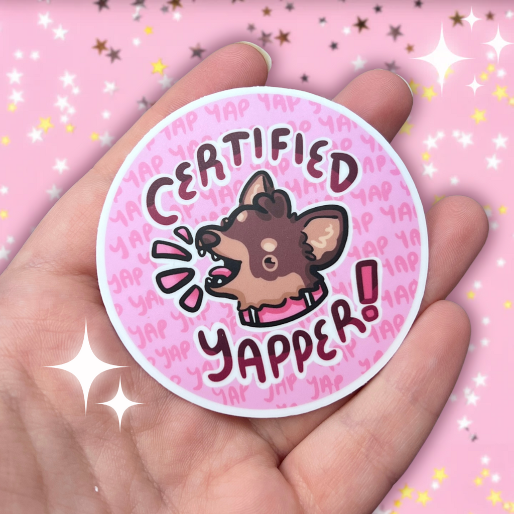 A sticker of a brown chihuahua with its mouth open, text that says "certified yapper" around it, and little yaps in the background