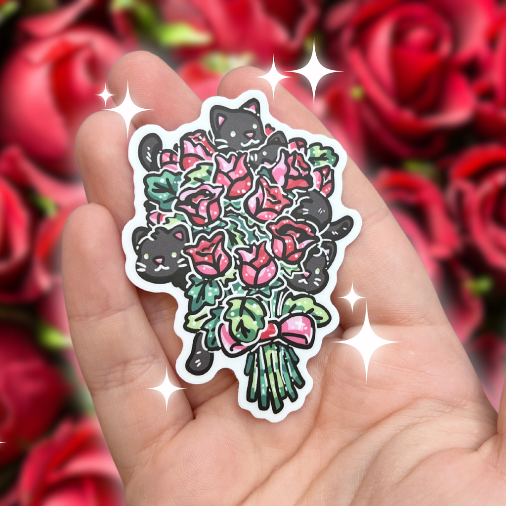 A sticker of a red/pink rose bouquet with a bunch of tiny black kittens sticking out