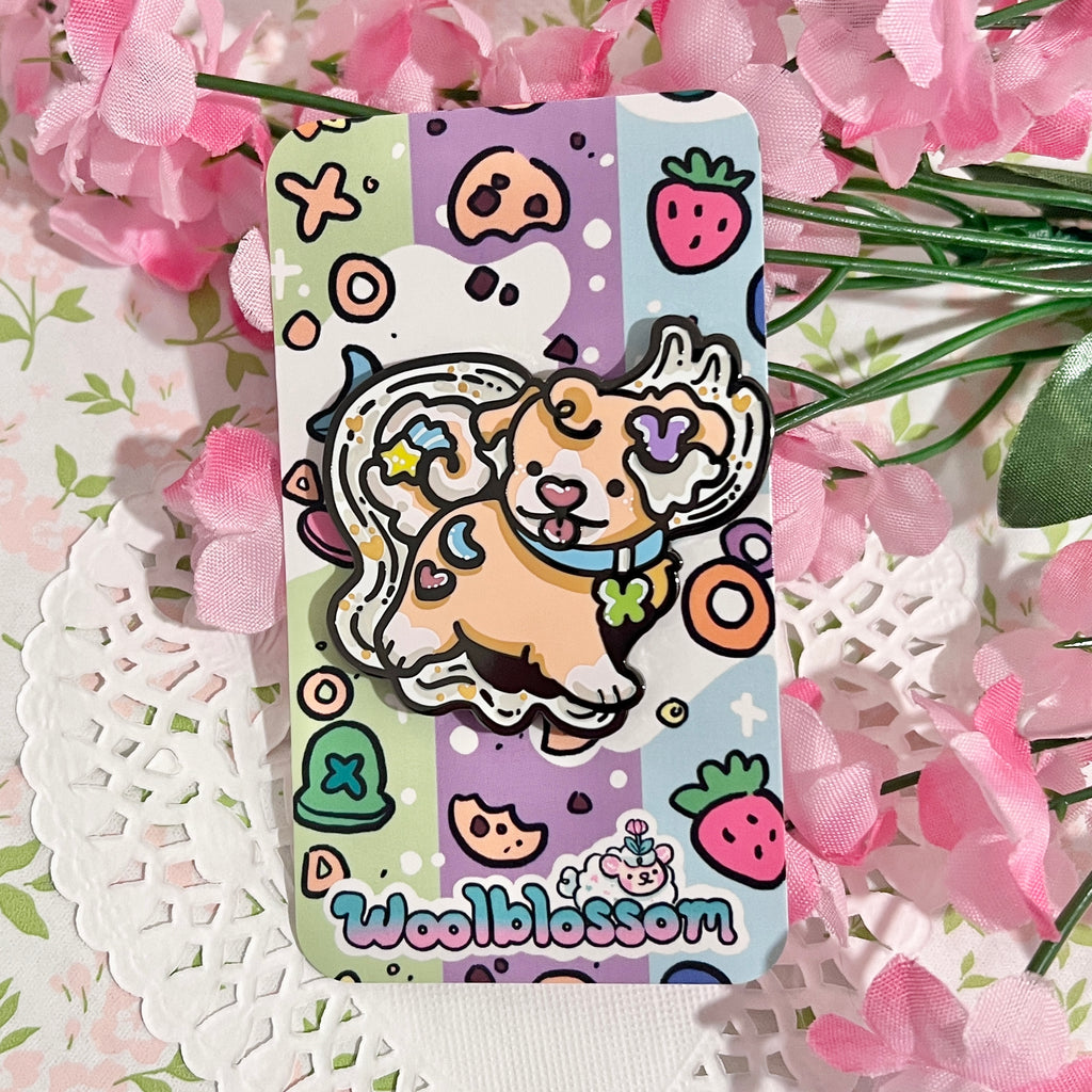 An enamel pin of a marshmallow cereal puppy in front of a wave of milk