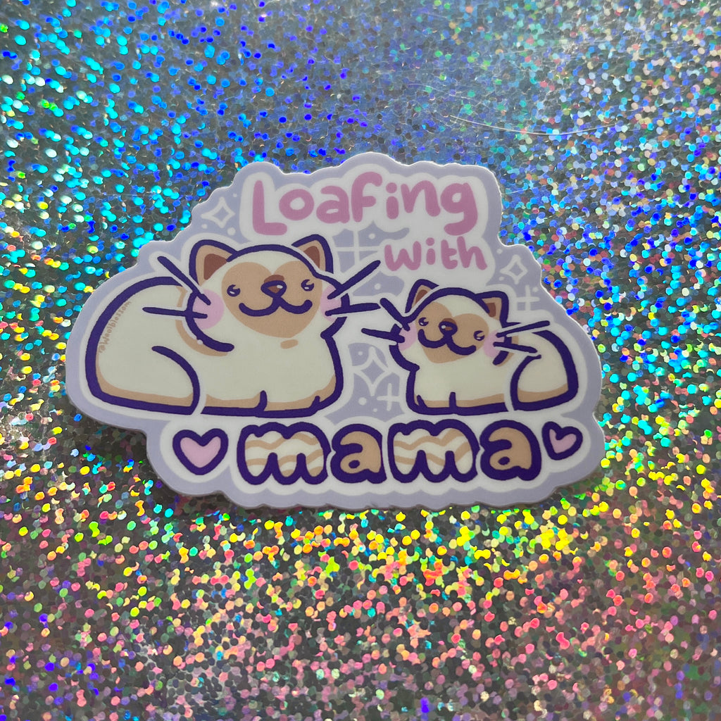 Sticker with cartoon cats and text 'Loafing with mama' on a glittery background