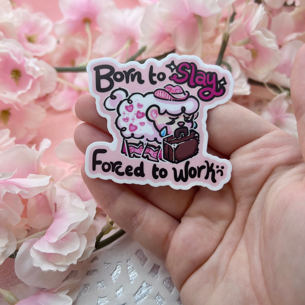 A sticker of sprout the sheep dressed in pink glitter cowgirl hat and boots, sadly holding a suitcase in their mouth. Text says "born to slay, forced to work"