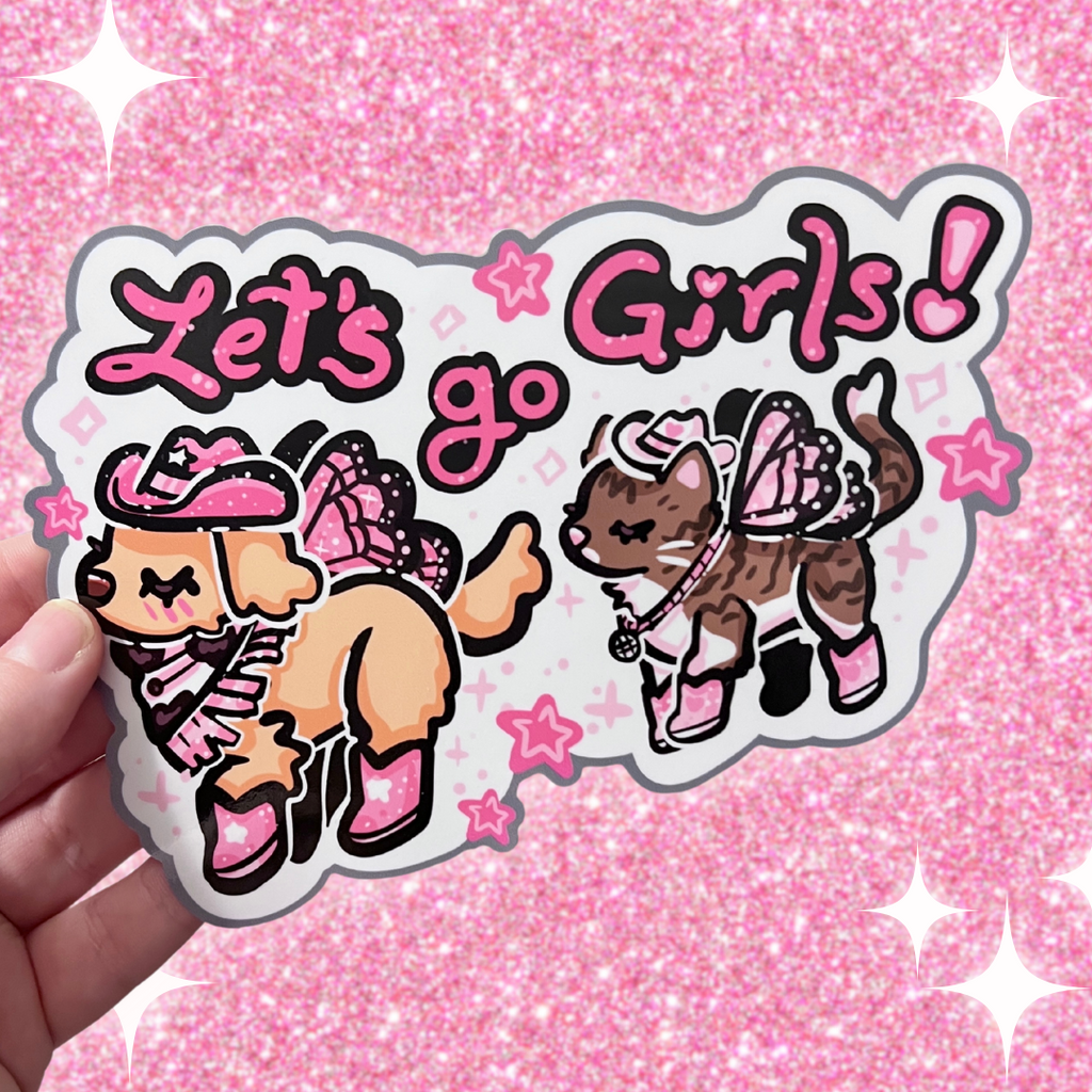 A bumper sticker of Two animals- one is a golden retreiver with a pink cowgirl hat, boots, and dark pink fairy wings. The second is a brown and white tabby cat with a white cowgirl haat, pink boots, and light pink butterfly wings. There is text that says "lets go girls!"