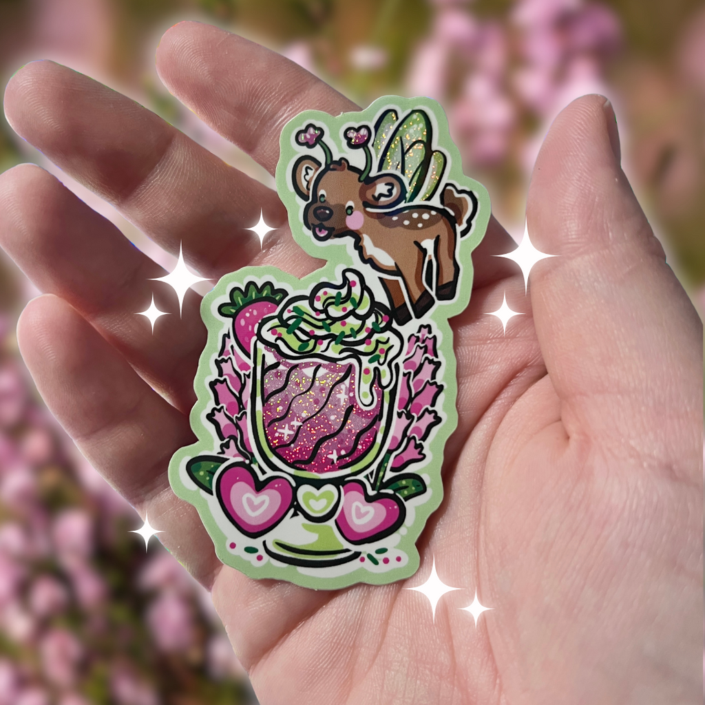 A sticker of a deer that is a fairy flying above a pink shake with heather flower behind