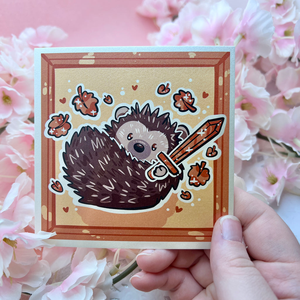 A print of a hedgedhog holding a sword with orange leaves falling around him