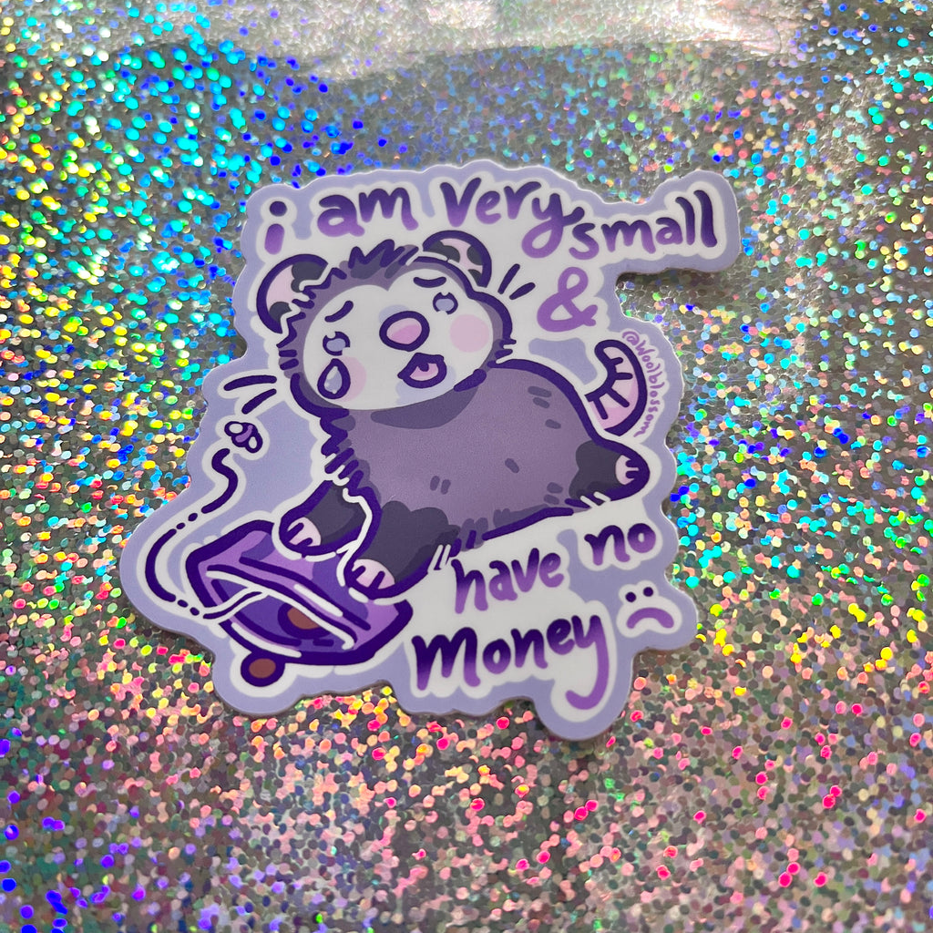 Sticker of a sad opossum with text that says "i am very small and have no money" on a glittery background