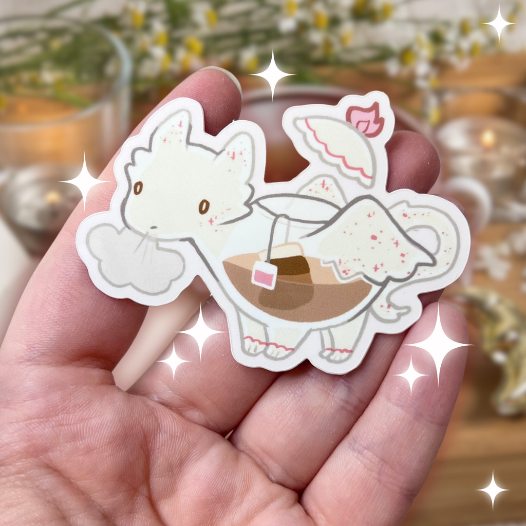 A sticker of a white dragon who is also a tea pot with tea in her stomach