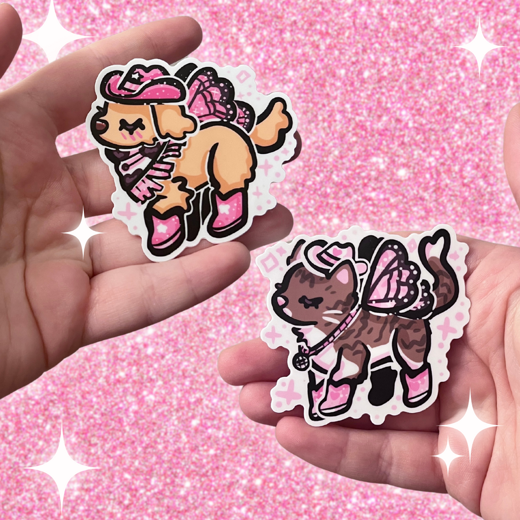 Two stickers- one is a golden retreiver with a pink cowgirl hat, boots, and dark pink fairy wings. The second is a brown and white tabby cat with a white cowgirl haat, pink boots, and light pink butterfly wings.