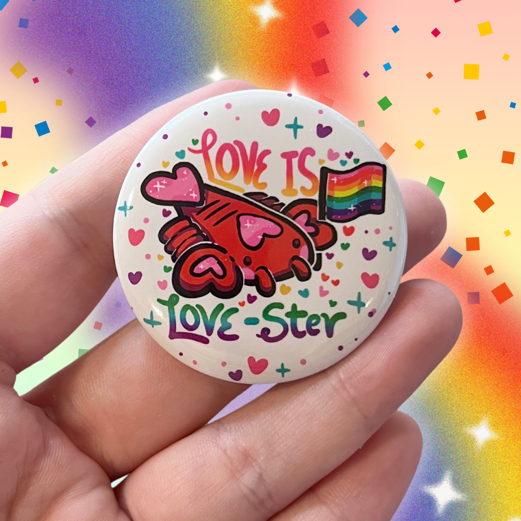 A button of a heart themed lobster holding a rainbow pride flag with text that says "love is love-ster"