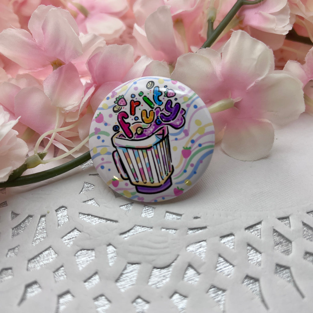 A button of a blender with fruit floating out and bubble rainbow text that says "fruity"