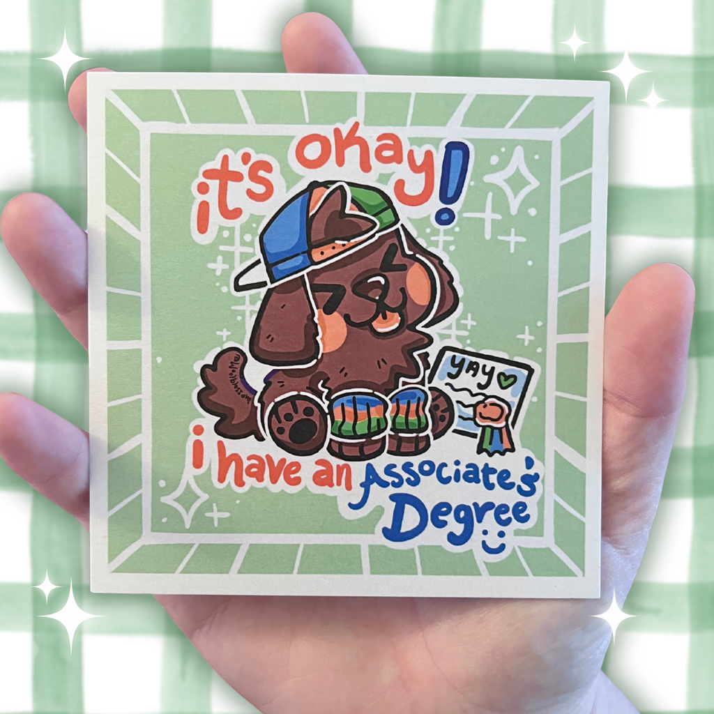 Card with cartoon character dog holding a degree and text 'it's okay! I have an Associate's Degree' on a green checkered background.