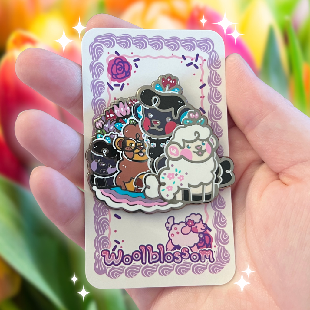 Hand holding a card with an enamel pin of cartoon animal sheep and 'Wooblossom' branding against a blurred floral background.