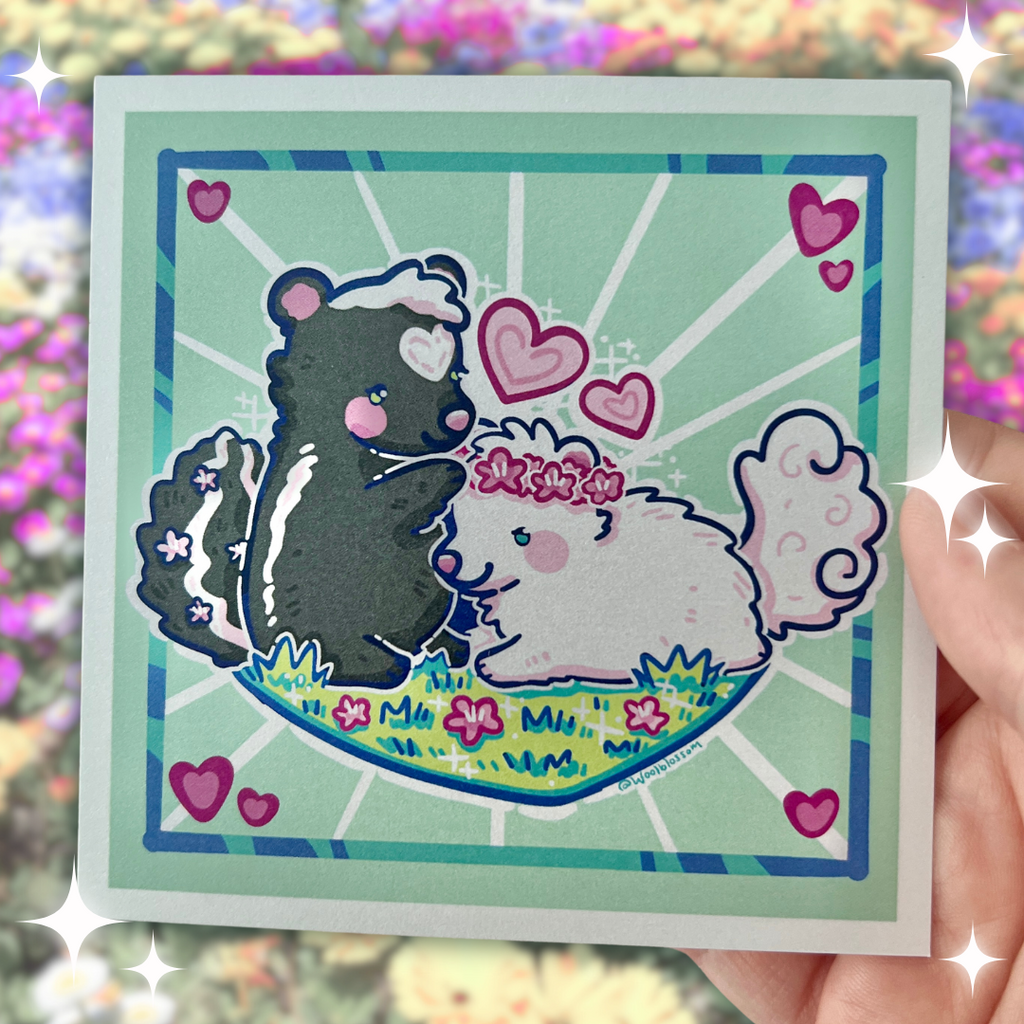 a print of Two skunks, one black and one white, on a patch of grass with the black putting a flower crown on the other