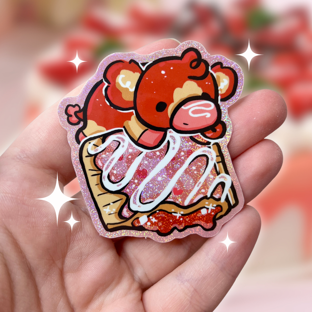 A sticker of a red and tan cow on top of a glitter pink strawberry pastry