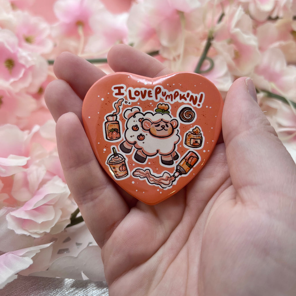 A button of a sheep with text that says "i love pumpkin!" and floating pumpkin themed items (candle, cofffee, etc.) all in a heart