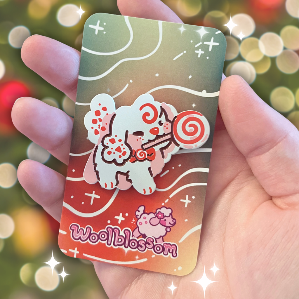 An enamel pin of a white peppermint puppy with a candy cane lollipop in its mouth