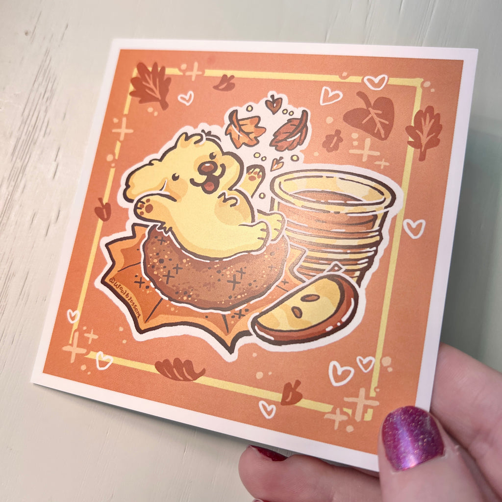 Cartoon dog on an apple doughnut on a print held by hand