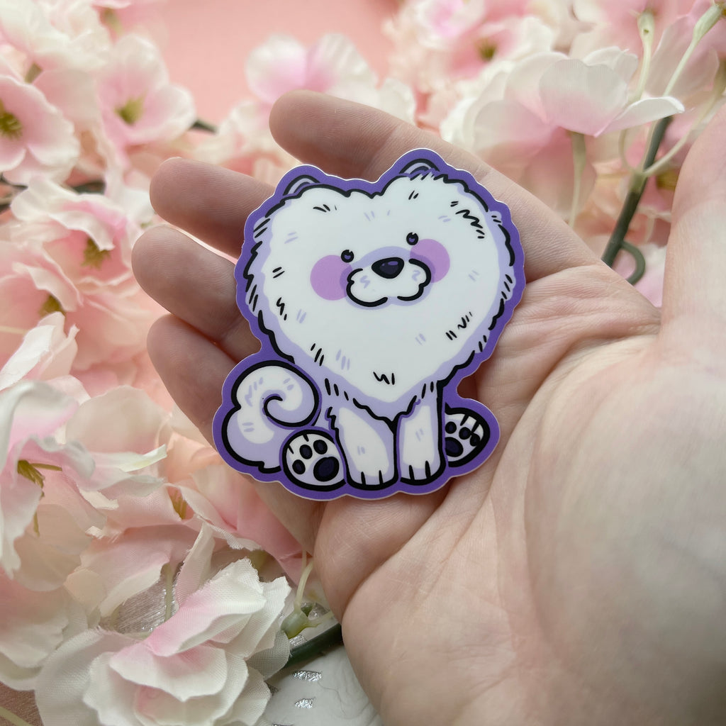 A sticker of a silly white dog with a haircut that makes its head look like a heart