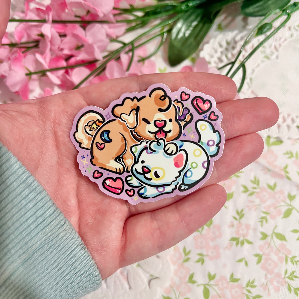 A sticker of a marshmallow cereal puppy laying/cuddling with a fruity cereal puppy with heart marshmallows