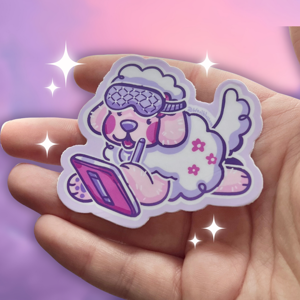 Hand holding a colorful sticker of a cartoon dog with sleep mask on drawing on an ipad