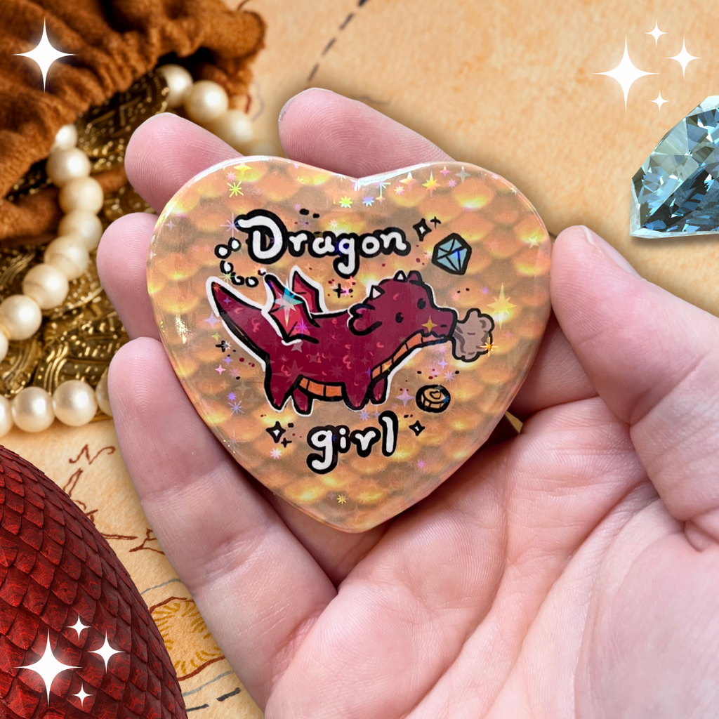 a heart button that says dragon girl with a red dragon in front of yellow scales