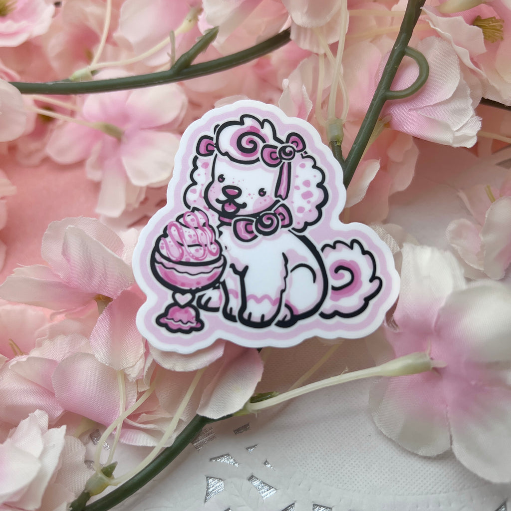 A sticker of a white puppy with pink accents and bows eating ice cream