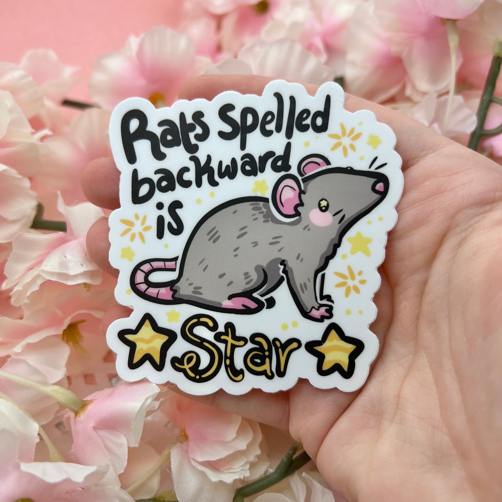 sticker of a gray rat with the text "rats spelled backward is star" and gold star accents