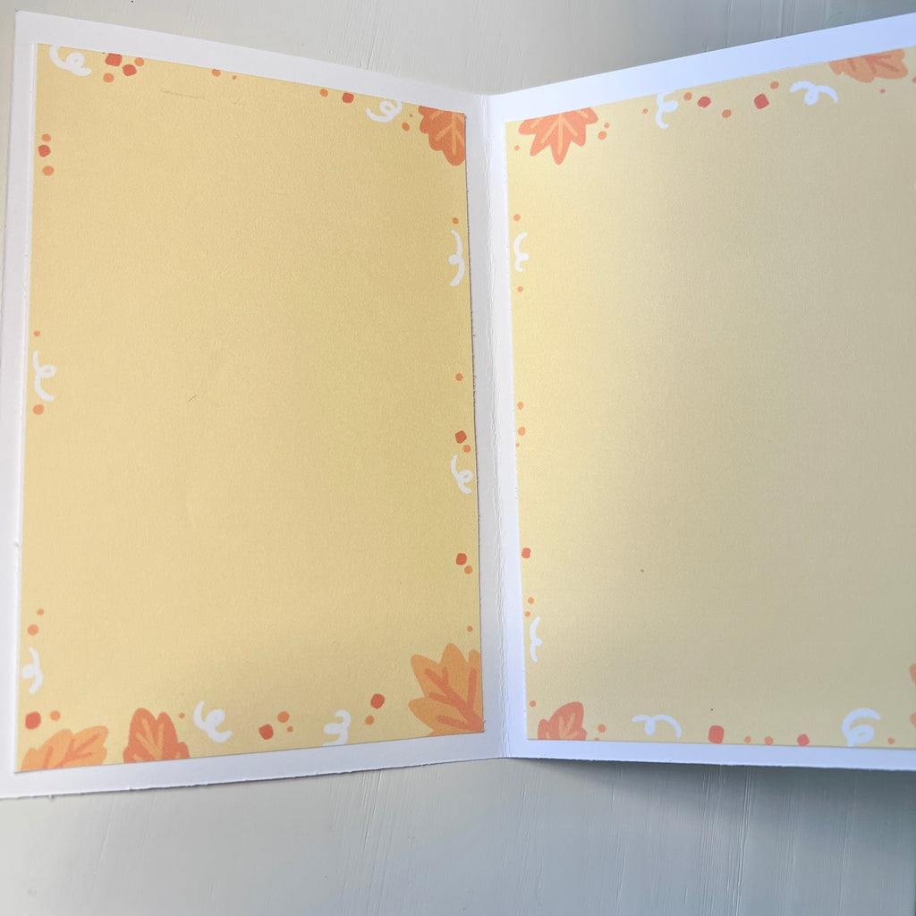 Open card with decorative pages on a plain background