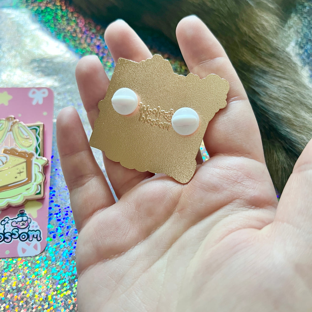 Backstamp of the pin held by a hand with a colorful background